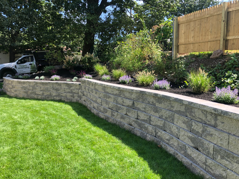 Stone retaining walls, plantings, lawns